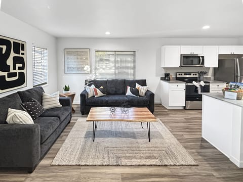 Relax in your stylish open-concept living space where modern comfort meets contemporary design. Sink into the plush sofa while natural light streams through large windows, creating the perfect atmosphere for unwinding after your CMU adventures.
