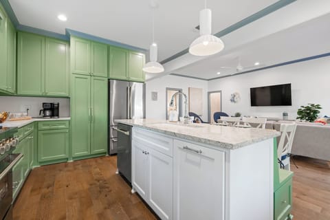 Full kitchen with all appliances and open to living room with smart TV and Sonos