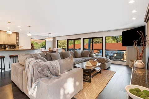 Living space with patio deck, open to kitchen.