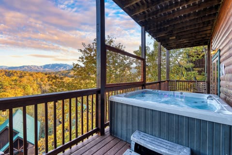 Soak in the private hot tub while taking in panoramic Smoky Mountain views from the covered deck.