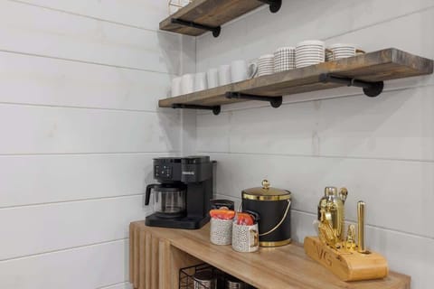 Charming coffee bar with Keurig, mugs, and gold-accent bar set for your morning brew.