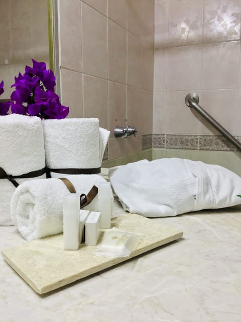 Junior Suite, 1 King Bed | Bathroom | Shower, free toiletries, hair dryer, towels