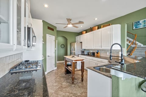 Fully equipped kitchen on the main entry level with full-size appliances, cookware, and essentials for family meals.