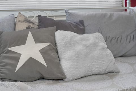 Soft grays and whites create a calming and chic area for relaxation.