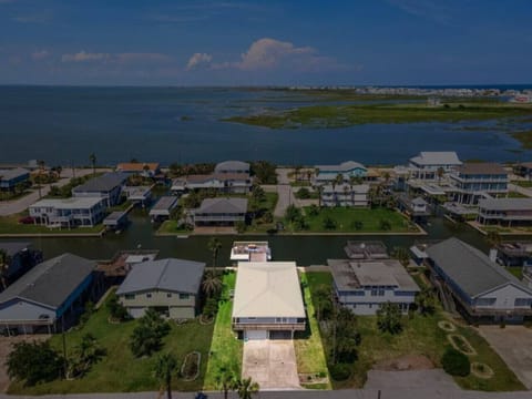 Enjoy the coastal charm of Anchor Down, a canal home in Sea Isle Subdivision, featuring an open-concept layout