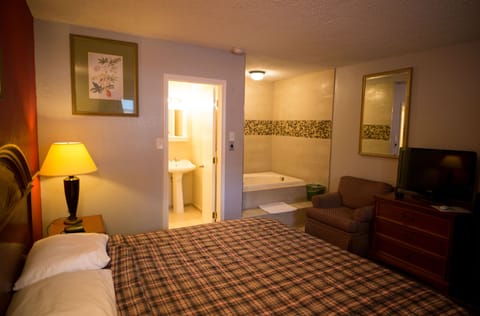 Suite, 1 King Bed, Jetted Tub | Desk, blackout drapes, iron/ironing board, rollaway beds