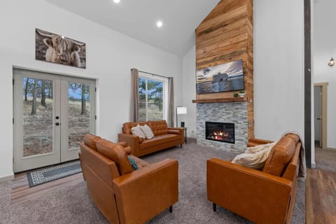 Cozy up in the vaulted living room with leather seating and a fireplace.