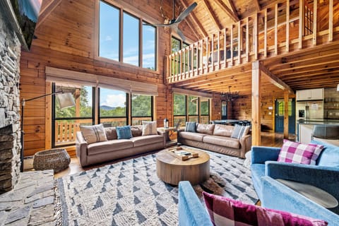 Open-concept living space with beautiful vaulted wooden ceilings.