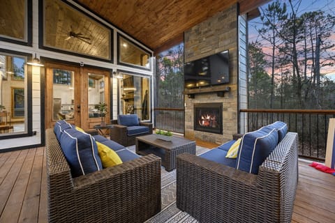 Under the covered breezeway, gather around the outdoor TV and fireplace, grill dinner, share meals, unwind in the hot tub, and cozy up on the conversation set.
