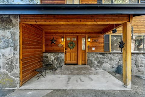 Cozy covered entry with rustic stone and wood accents