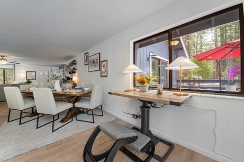Desk looks over to master bedroom and outside greenbelt