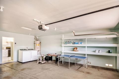 Garage game area with ping-pong table plus in-home washer and dryer for your convenience.
