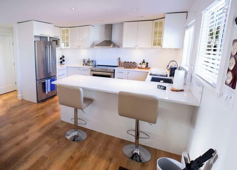 Kitchen features 2 bar stools