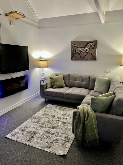 Family Studio Suite, Fireplace, Garden View | Living area | Flat-screen TV, DVD player
