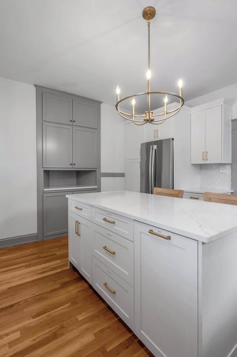 A warm, polished culinary space with modern appliances, ample storage, and a roomy island ideal for sharing meals and moments.