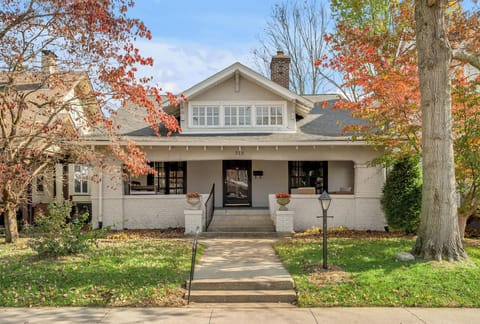 A warm and appealing home with a spacious front porch and seasonal foliage. Perfect for relaxing outdoors while enjoying a peaceful neighborhood setting.