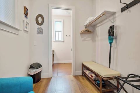 This hallway nook offers practical storage with shelving and seating for organizing gear or personal items. Its placement near the bedrooms keeps everything easily accessible without interrupting the home’s clean flow.