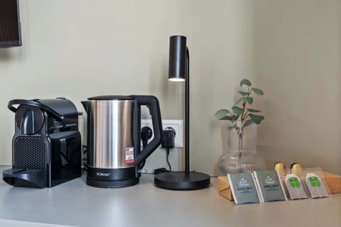 Desk space with a coffee maker and kettle for added convenience.