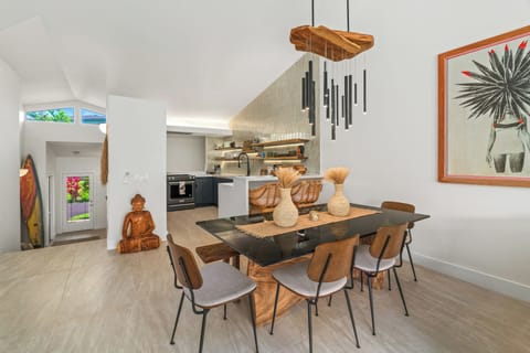 Gather around this handcrafted dining table under sculptural pendant lights.