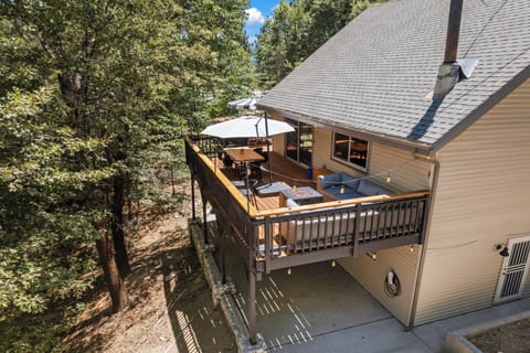 Spacious forest-view deck with firepit and outdoor dining — your private mountain retreat among the trees.