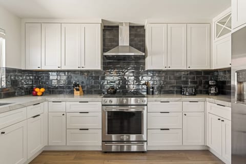 Fully stocked kitchen with reliable appliances and ample counter space for meal prepping.