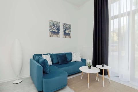 Relax in the stylish living area with a comfortable sofa and modern decor.