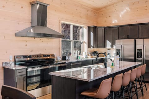 This kitchen is equipped 2 ranges, 2 sinks, 2 refrigerators, and 2 dishwashers