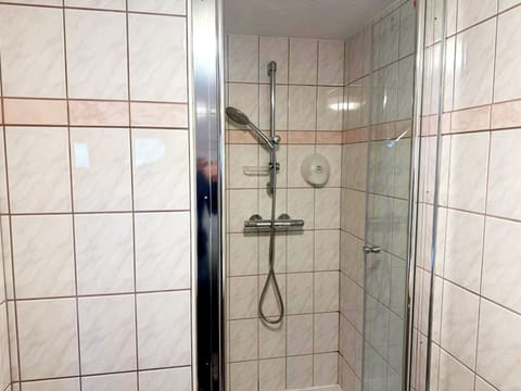 Shower, hair dryer, towels, toilet paper