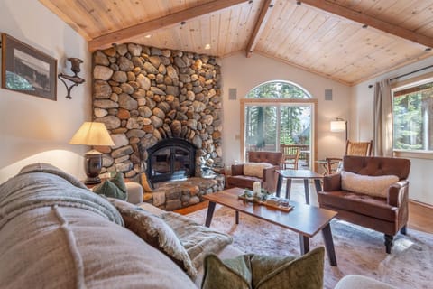 Curl up in this cozy living room, where vaulted wood ceilings and forest views create the perfect mountain retreat for unwinding after your adventures.