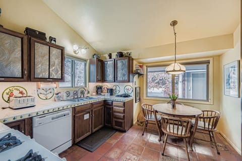 Your fully equipped kitchen awaits with charming rustic details and mountain views through large windows. Whip up your favorite meals with quality appliances and enjoy casual dining at your cozy breakfast nook.