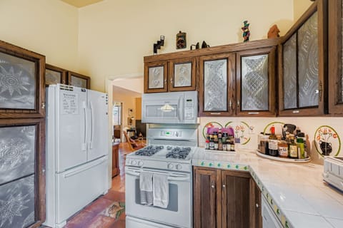 Step into your fully equipped kitchen where you'll find everything you need to create delicious meals during your stay. Rich wood cabinets with decorative glass panels and modern appliances make cooking a pleasure.