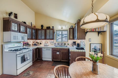 Step into your spacious kitchen where rustic charm meets modern convenience. Natural light pours through large windows as you prepare meals with full appliances and ample counter space.