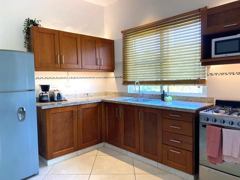 Deluxe Apartment, 1 Bedroom, Pool View | Private kitchen | Full-size fridge, microwave, stovetop, coffee/tea maker