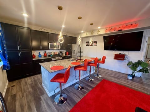 Bright, open kitchen with a large island and bar stools, perfect for cooking and hanging out together. There are plenty of cabinets and modern appliances to make meal prep easy.
