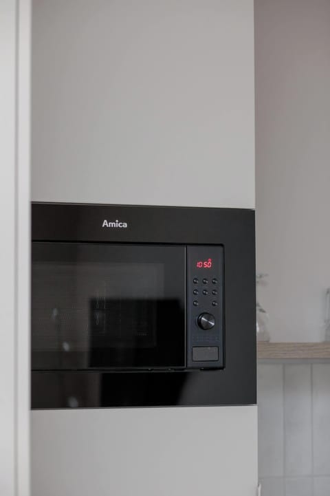 Built-in cabinetry with modern appliances for added convenience.