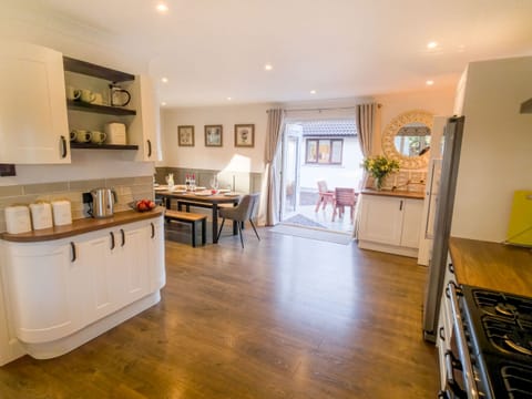 A bright, contemporary kitchen with white cabinets and wooden countertops perfect for family holidays