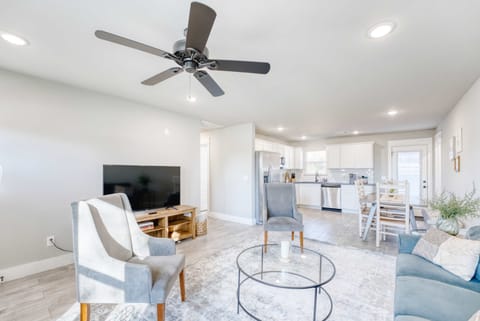 Bright and airy open-concept living space with modern finishes, cozy seating, and a seamless flow into a fully equipped kitchen.