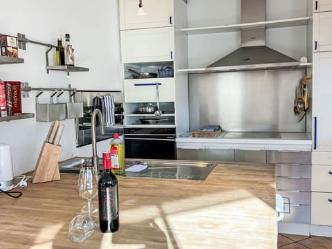 Furniture, Kitchen, Interior Design, Flooring, Countertop, Wood, Cabinetry, Kitchen Appliance, Floor, Lighting