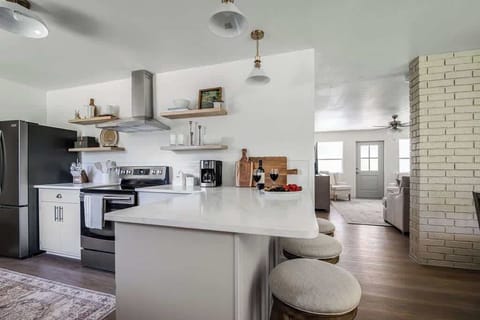 The kitchen features a spacious countertop with bar seating, creating a casual spot for dining, morning coffee, or conversation while cooking.