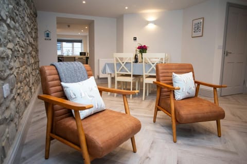 Living and dining area, two armchairs, view of dining area with table and chairs