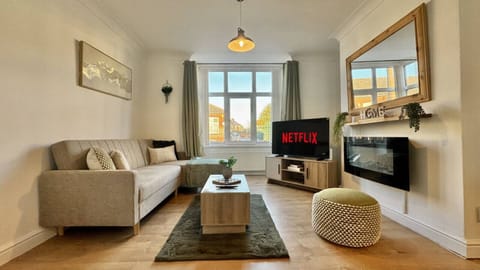 Bright and stylish living room with large window and TV
