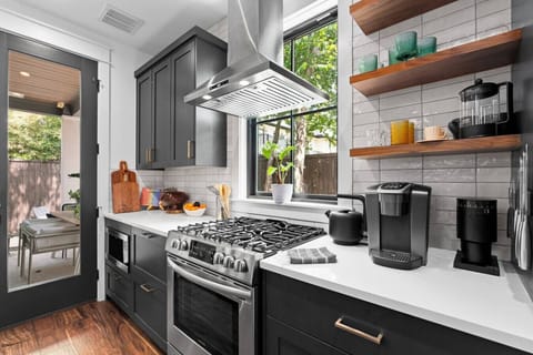 Modern kitchen featuring generous counter space, sleek storage, and full appliances.
