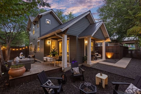 Modern two-story home with a cozy porch and inviting backyard seating.