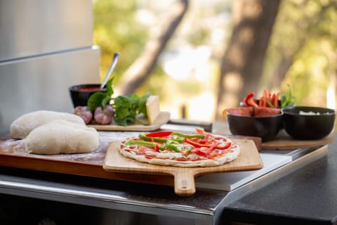 Pizza night made easy—prep your dough, & toppings right beside the pizza oven