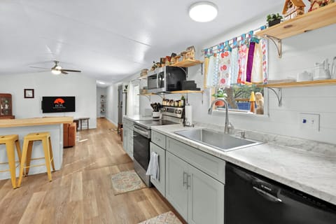 The kitchen is behind the living room