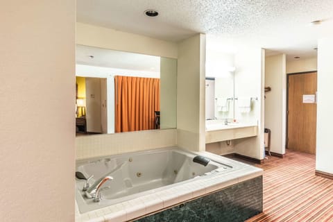 Suite, 1 King Bed, Non Smoking | Bathroom | Combined shower/tub, hydromassage showerhead, hair dryer, towels