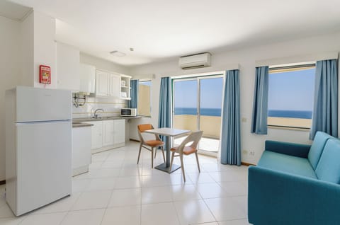 Apartment, 1 Bedroom, Sea View (Front) | Living area | Flat-screen TV