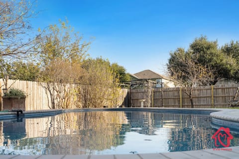 Tranquil backyard oasis with refreshing swimming pool.