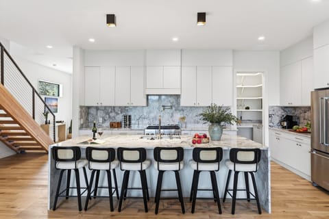 Stunning marble kitchen with bar seating.