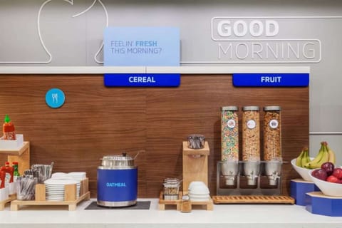 Self-serve breakfast station with cereal, oatmeal, and fruit
